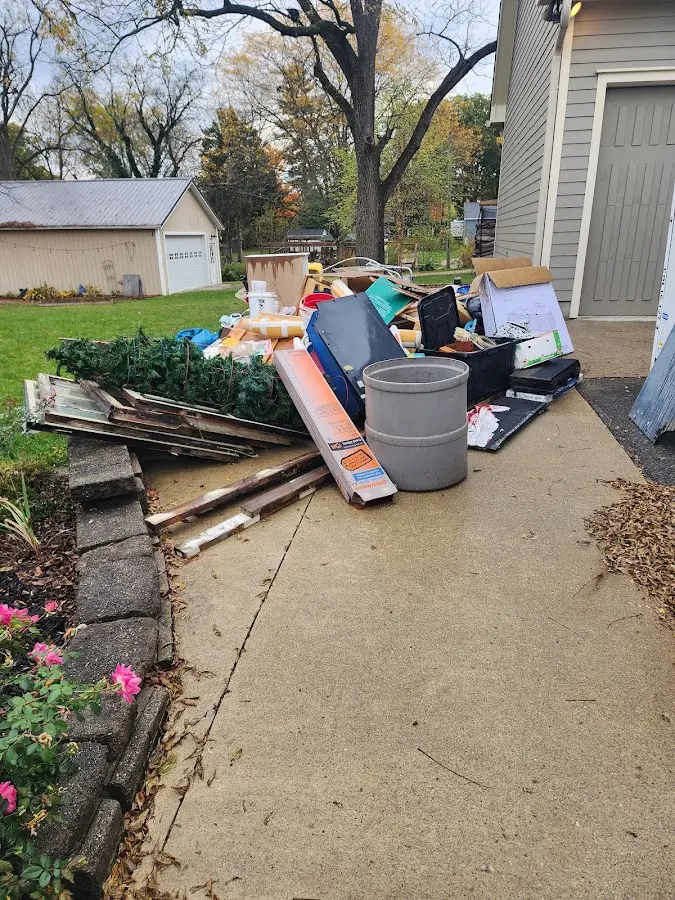 Dumpster being loaded with debris for Estate Cleanout Dumpster Rental in Mexia